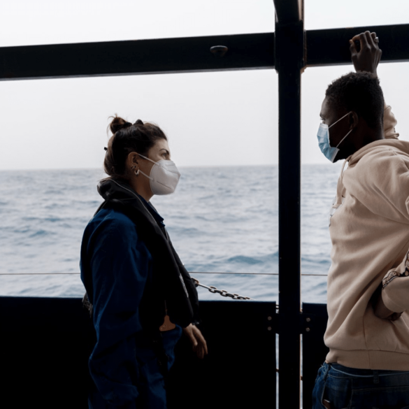 Rachele talking to a guest on board the Sea-Watch 3 in 2022