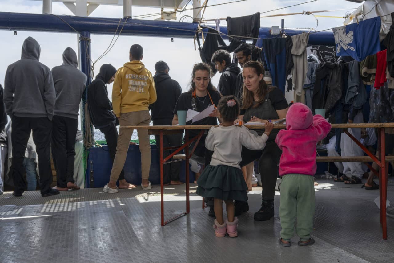 two children interacting with crew